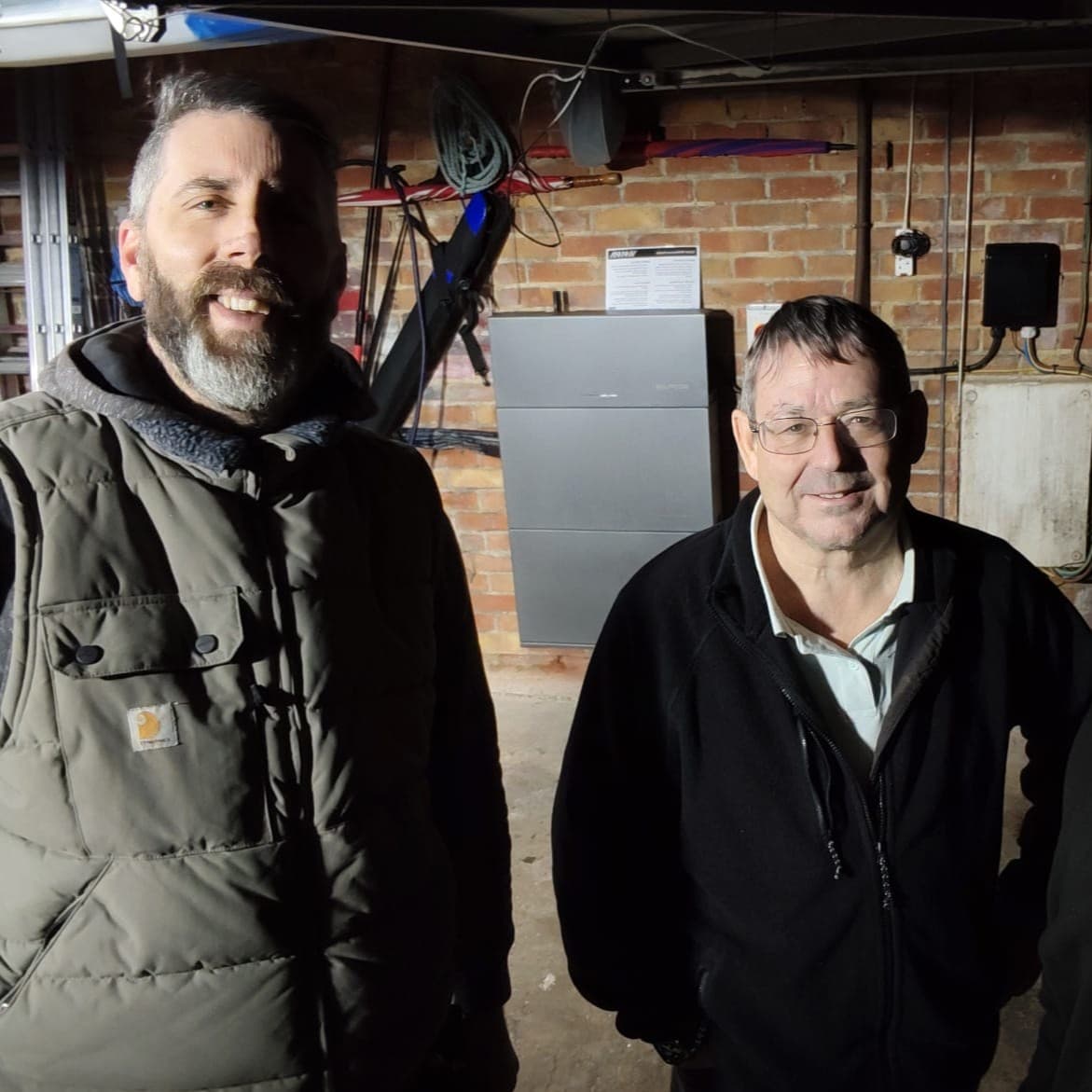 Vimma team beside a newly installed battery system