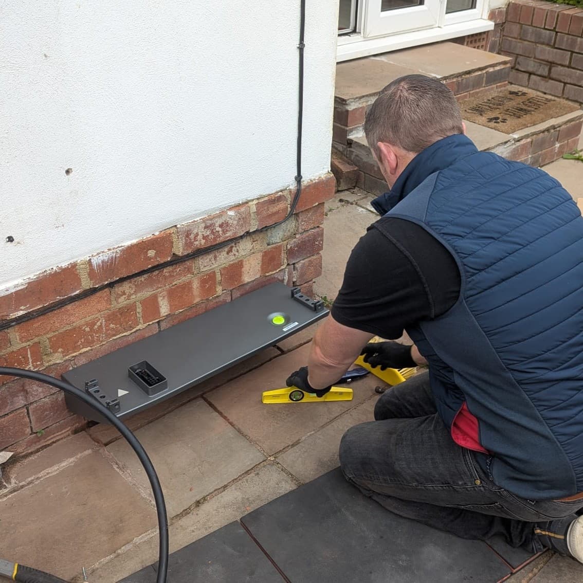 Vimma installer levelling an EV charger mount